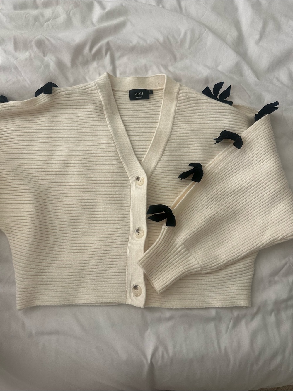 Brand New VICI Cream Ribbed V-Neck Cardigan with Black Bow Accents